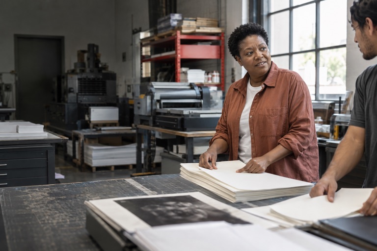 Print shop owner talking with a colleague